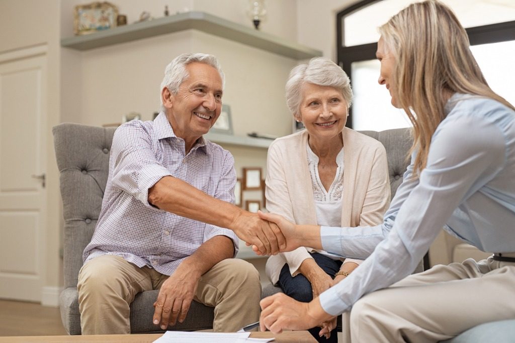 senior-couple-shaking-hands-with-financial-advisor-picture-id1029343906-1024x683.jpg
